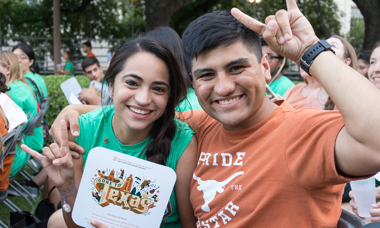 two new students looking at the camera at an outdoor welcome event